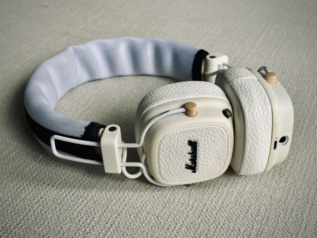 Restored Marshall Major III headphones with replacement ear pads and a fabric headband cover on a light-coloured surface.